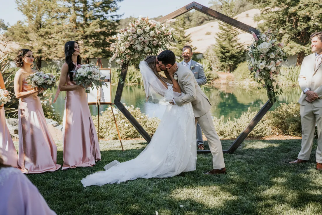 ceremony hectagonal arch in front of pond